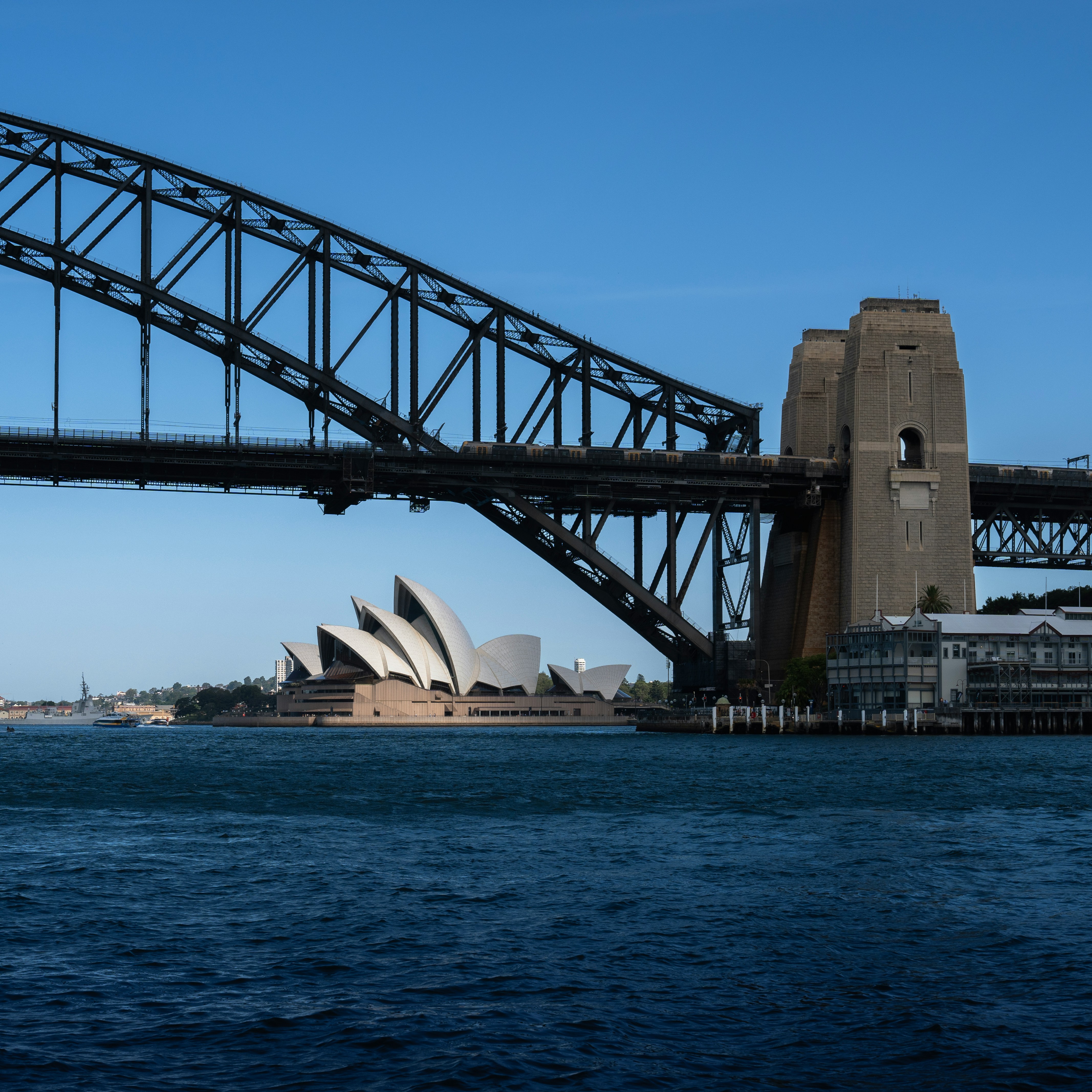 Sydney Harbour Bridge stretching across the water with the Opera House in the background